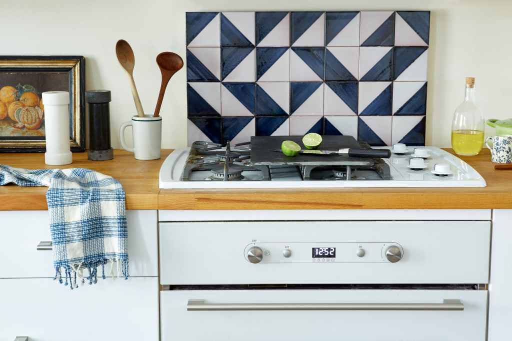 kitchen stove with geometric tile backsplash design and modern countertop styling