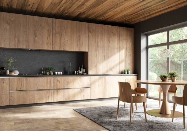 Modern kitchen with wood cabinets and dining area by large windows