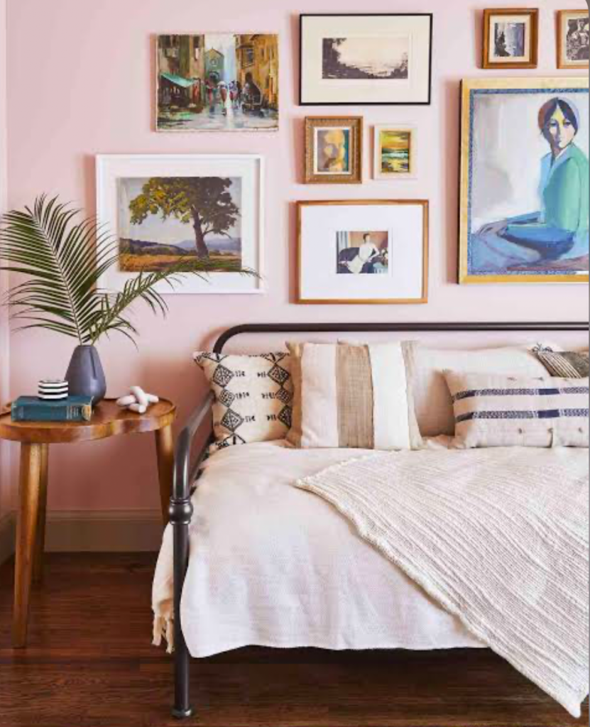 Minimalist bedroom with pink wall and framed art