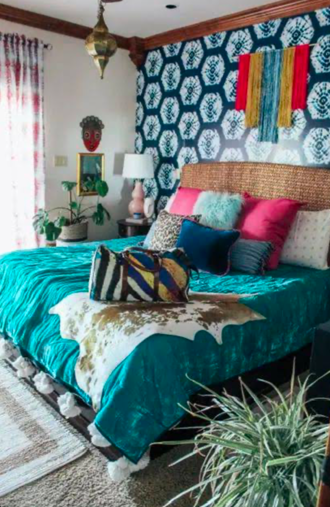 Eclectic bedroom with teal bedding and patterned wall