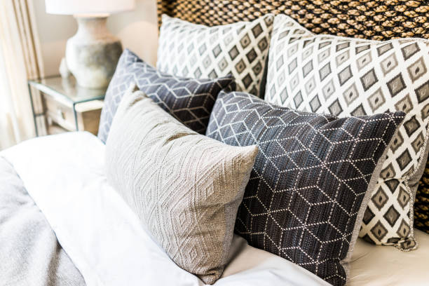 Decorative pillows with geometric patterns on a bed.