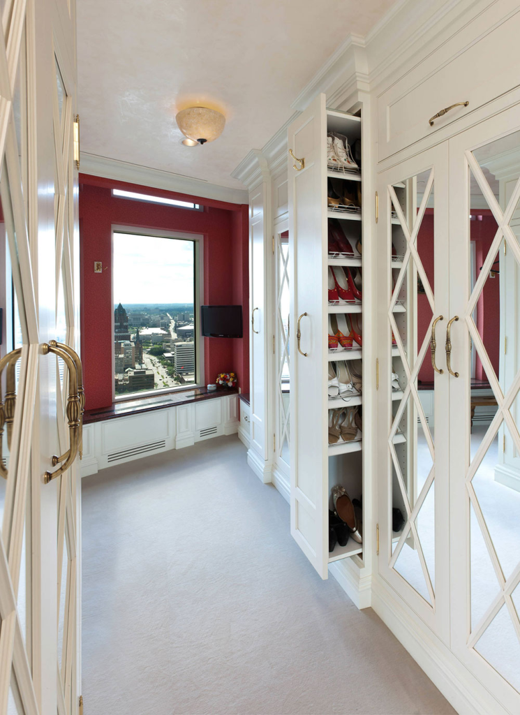 Elegant closet with pull-out vertical shoe racks and mirrored doors