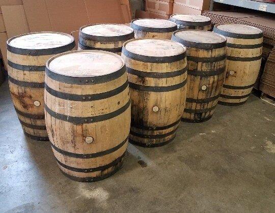 Group of used wine barrels arranged in a storage area