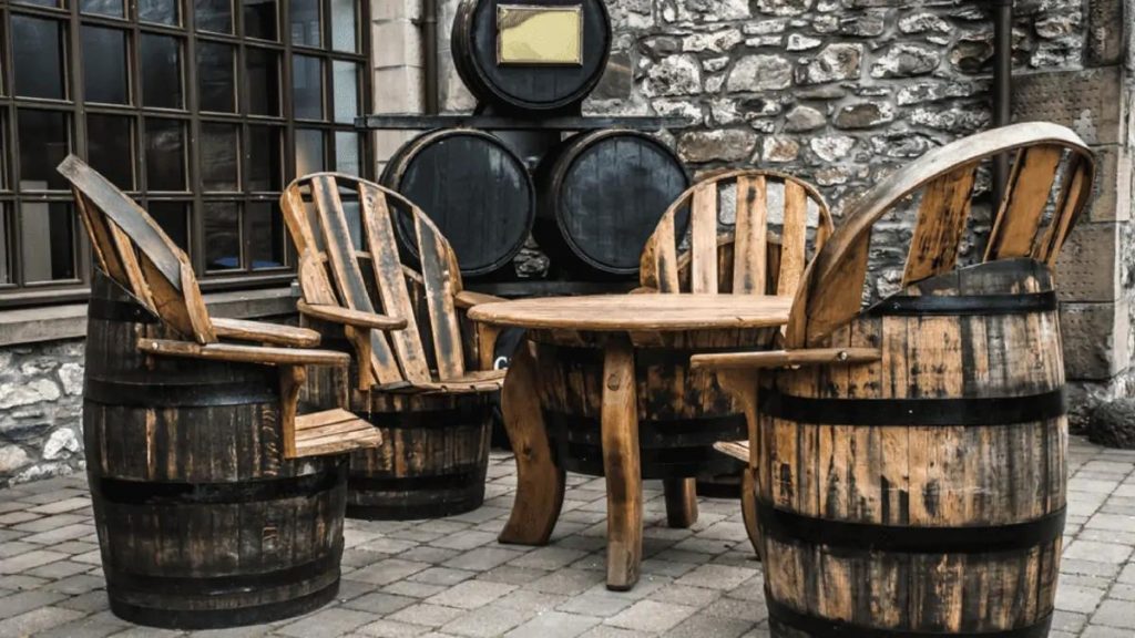 Outdoor patio set with chairs and a round table made from repurposed barrels