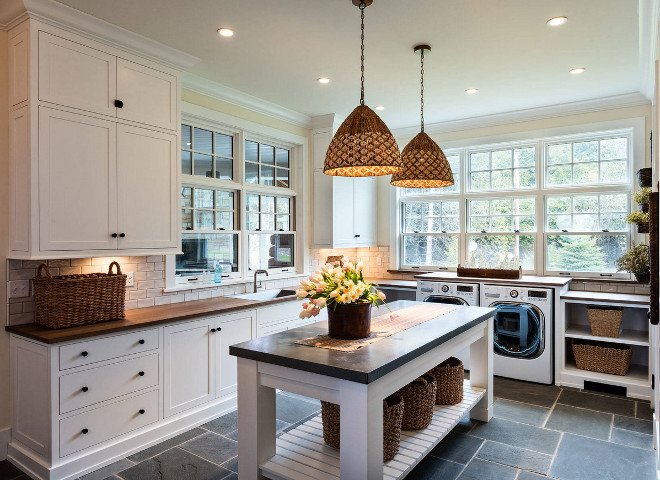 A laundry room with an island.