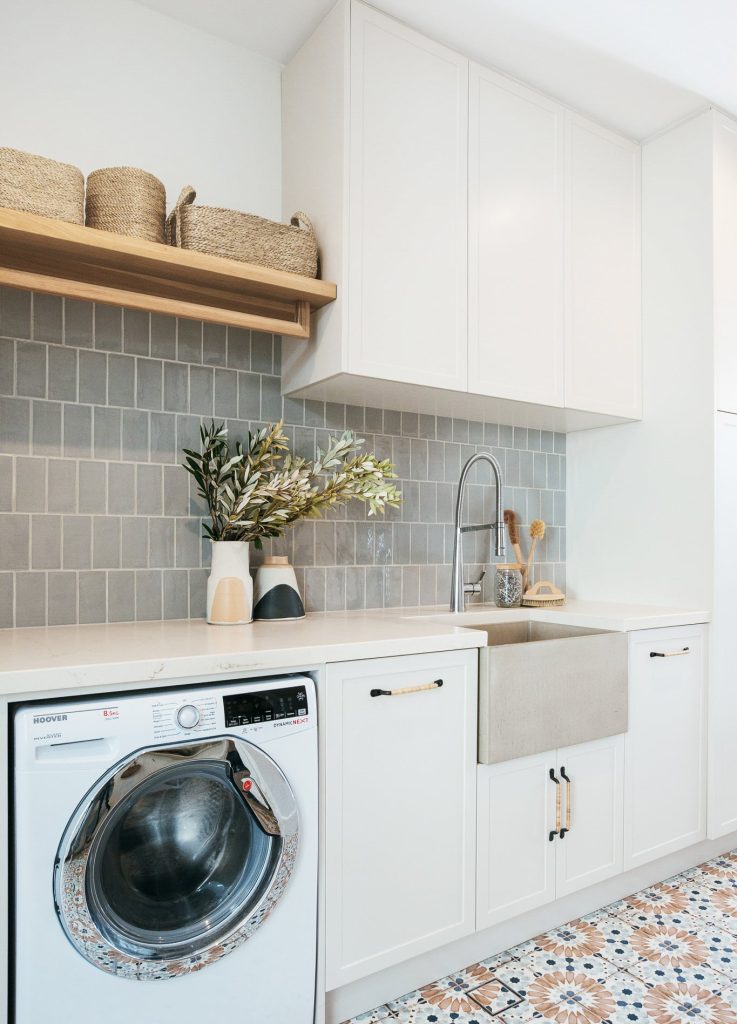 Patterned floor tiles on laundry room walls.