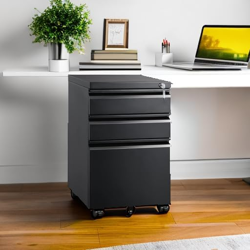 A black mobile filing cabinet with three drawers and lock placed beside a desk in a modern workspace.