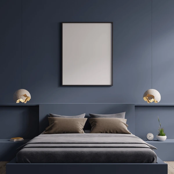 Dark blue bedroom with modern pendant lights and neutral bedding.