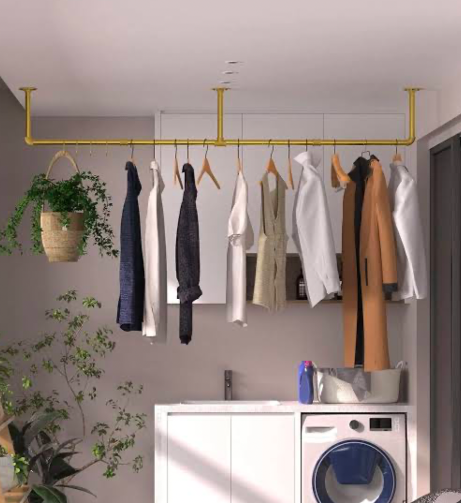 Ceiling-mounted drying rack with clothes hanging above a laundry unit