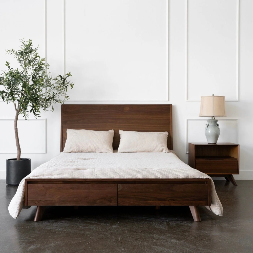 Minimalist bedroom with wooden bed frame and neutral tones.