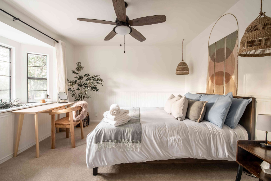 Scandinavian bedroom featuring a desk by the window and modern decor