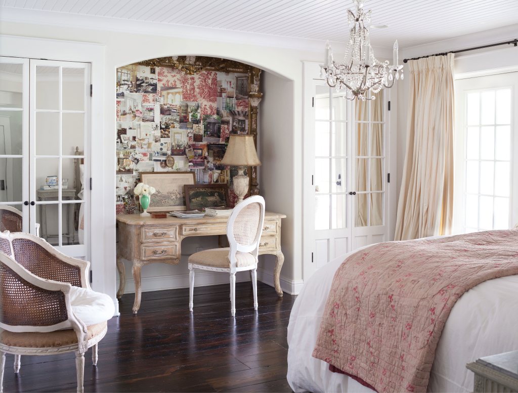 Vintage-style bedroom workspace with ornate desk and gallery wall
