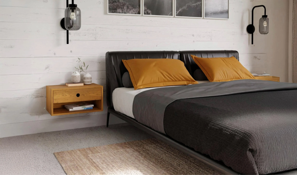 Modern bedroom with mustard pillows and sleek black frame.
