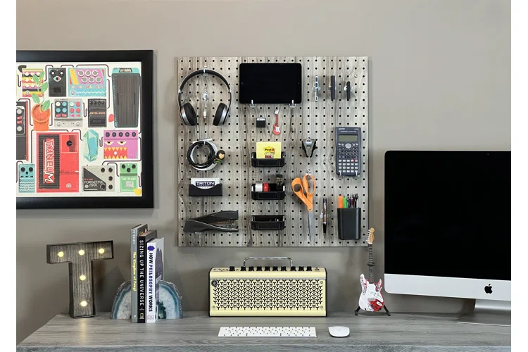 Creative workspace with pegboard wall organizer and various tools