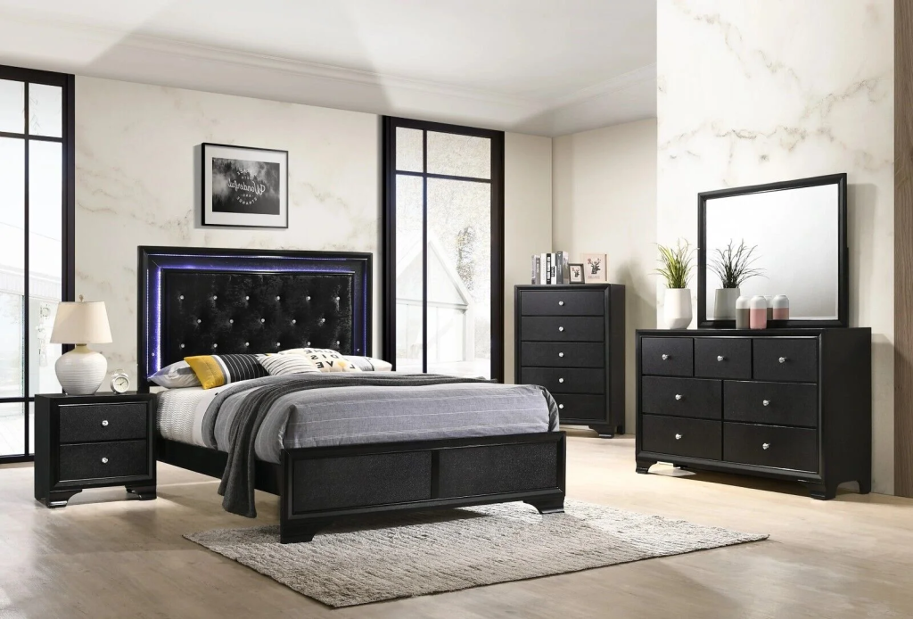 Modern bedroom with a tufted black headboard and matching furniture.
