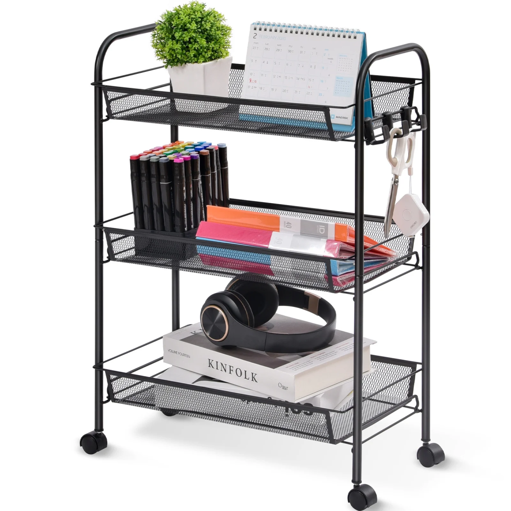 Black mesh rolling cart with three tiers filled with books, pens, and decor.