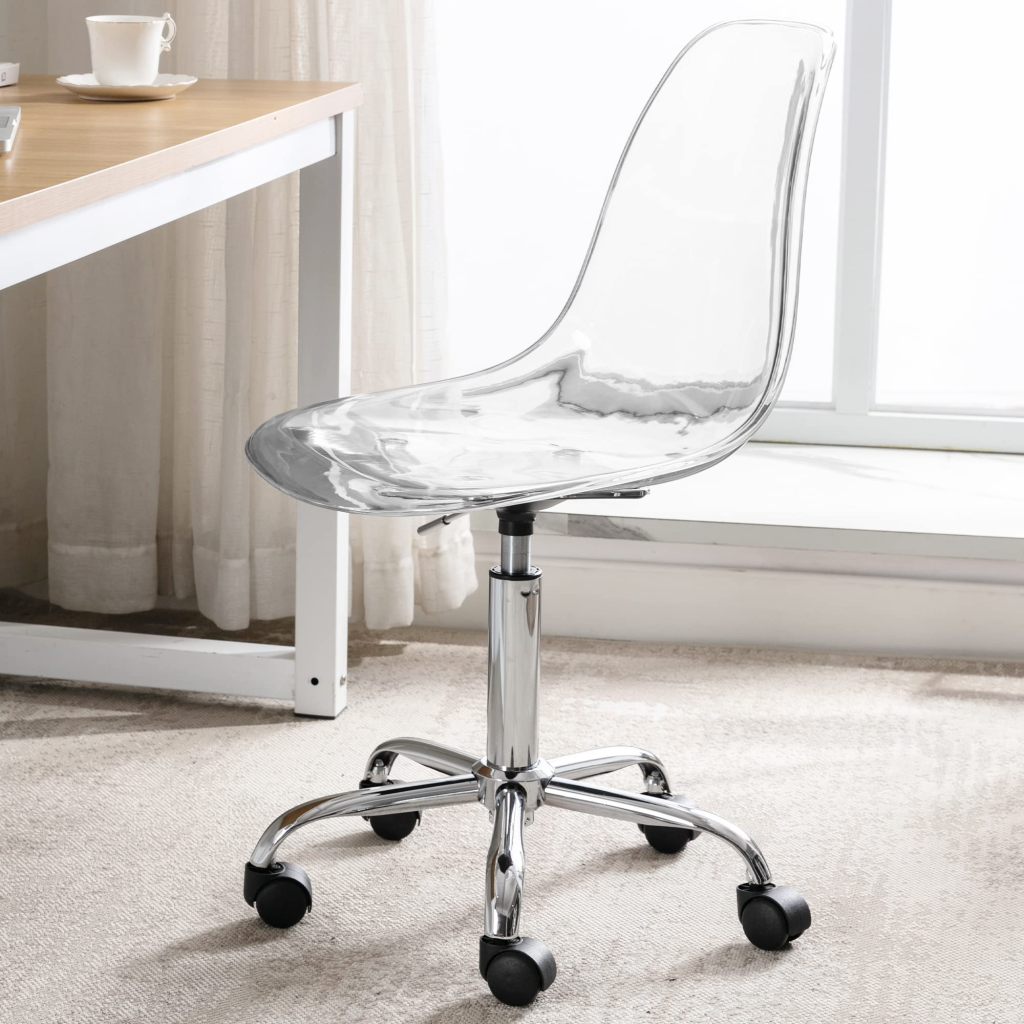 Transparent acrylic office chair with chrome legs and wheels beside a wooden desk in a bright room.