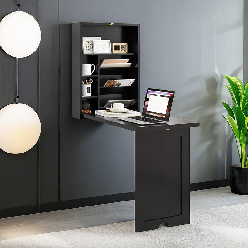 Foldable wall-mounted black desk with shelves and a laptop, ideal for small spaces and modern interiors.