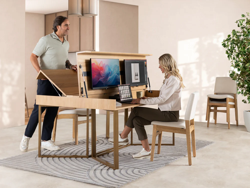 Dual workspace with adjustable desks housing two monitors, accommodating both sitting and standing positions.