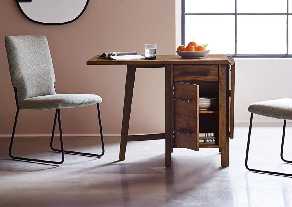 Compact foldable dining table with storage and modern chairs in a cozy room.