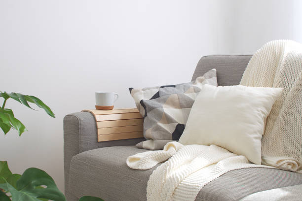 Cozy armchair with decorative pillows and knitted throw