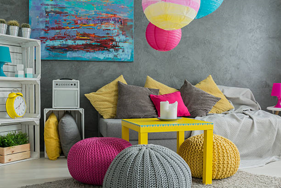Eclectic gray room with poufs and lanterns