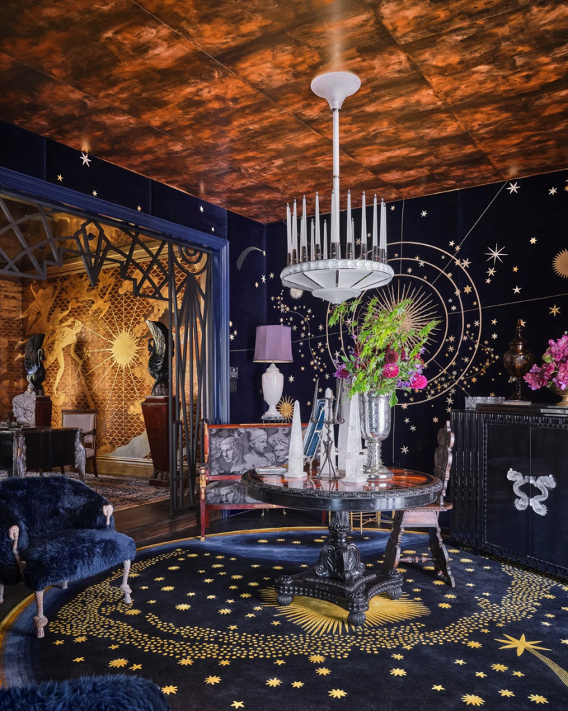 Celestial dining room with starry astrology mural and copper ceiling.