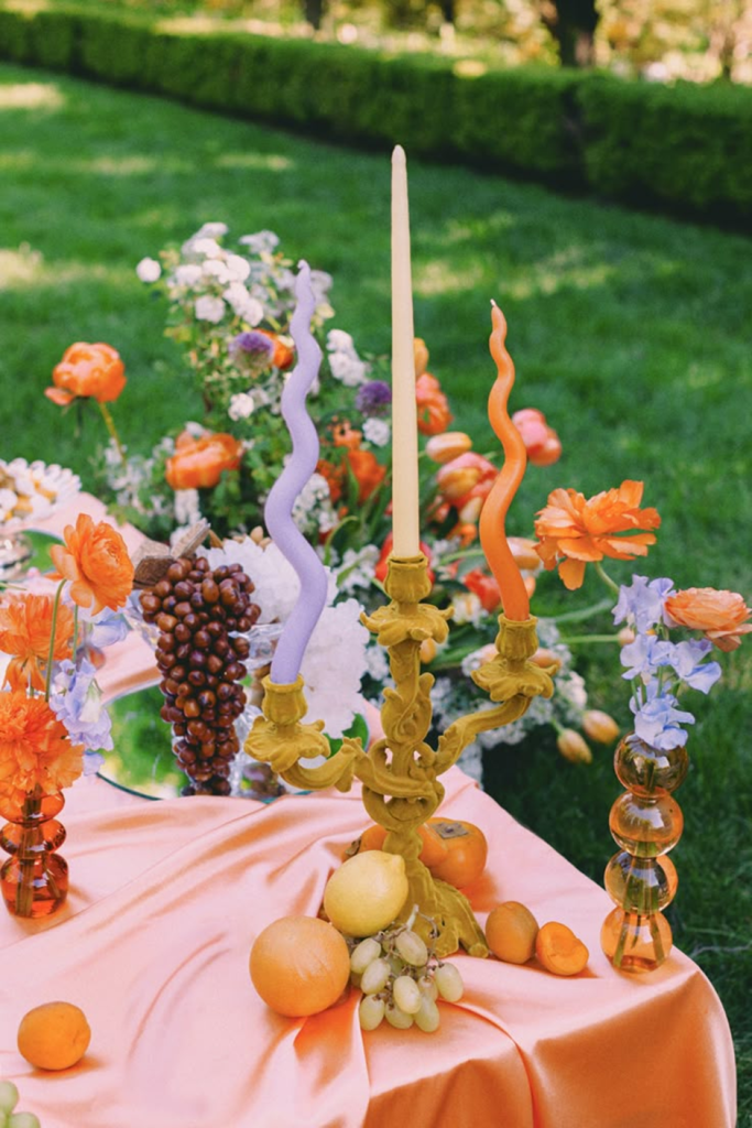 Garden tablescape with wavy tapers, citrus and florals.