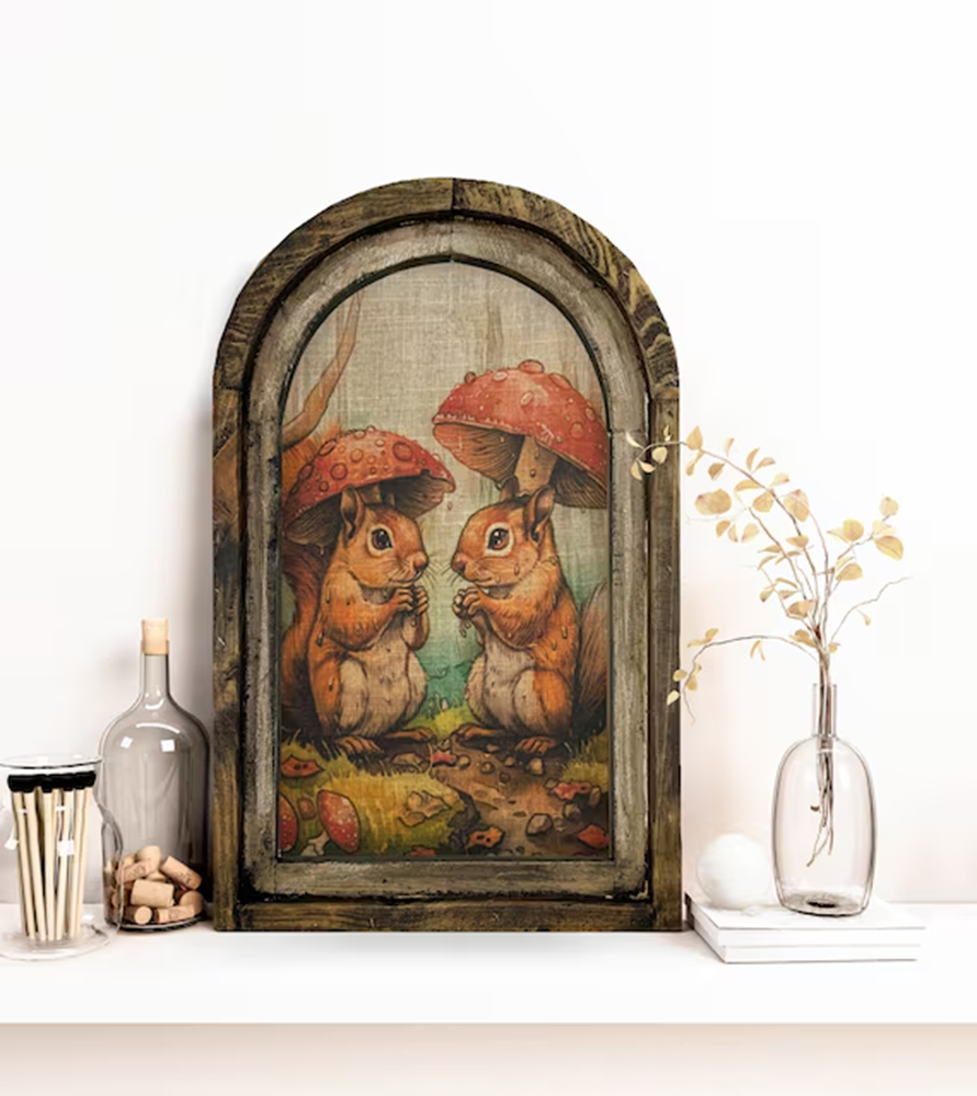 Whimsical squirrel illustration under toadstool mushrooms in rustic frame
