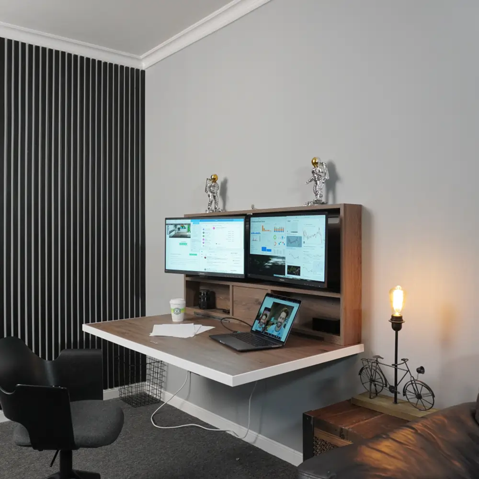Space-saving home office with wall-mounted desk and dual monitors