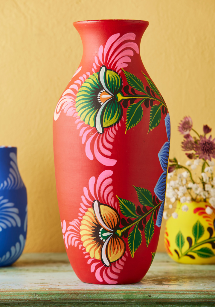 Close-up of red hand-painted floral vase, boho home decor