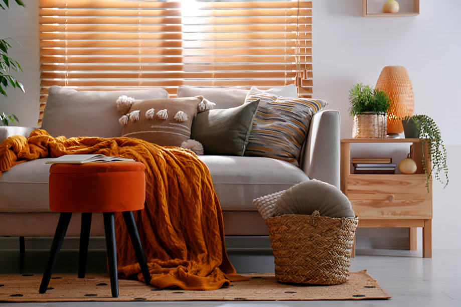 Modern sofa with mustard throw, green pillows and ottoman