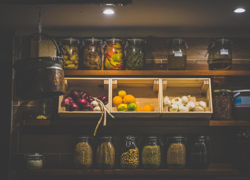 Wooden crates being used as storage in a rustic pantry.