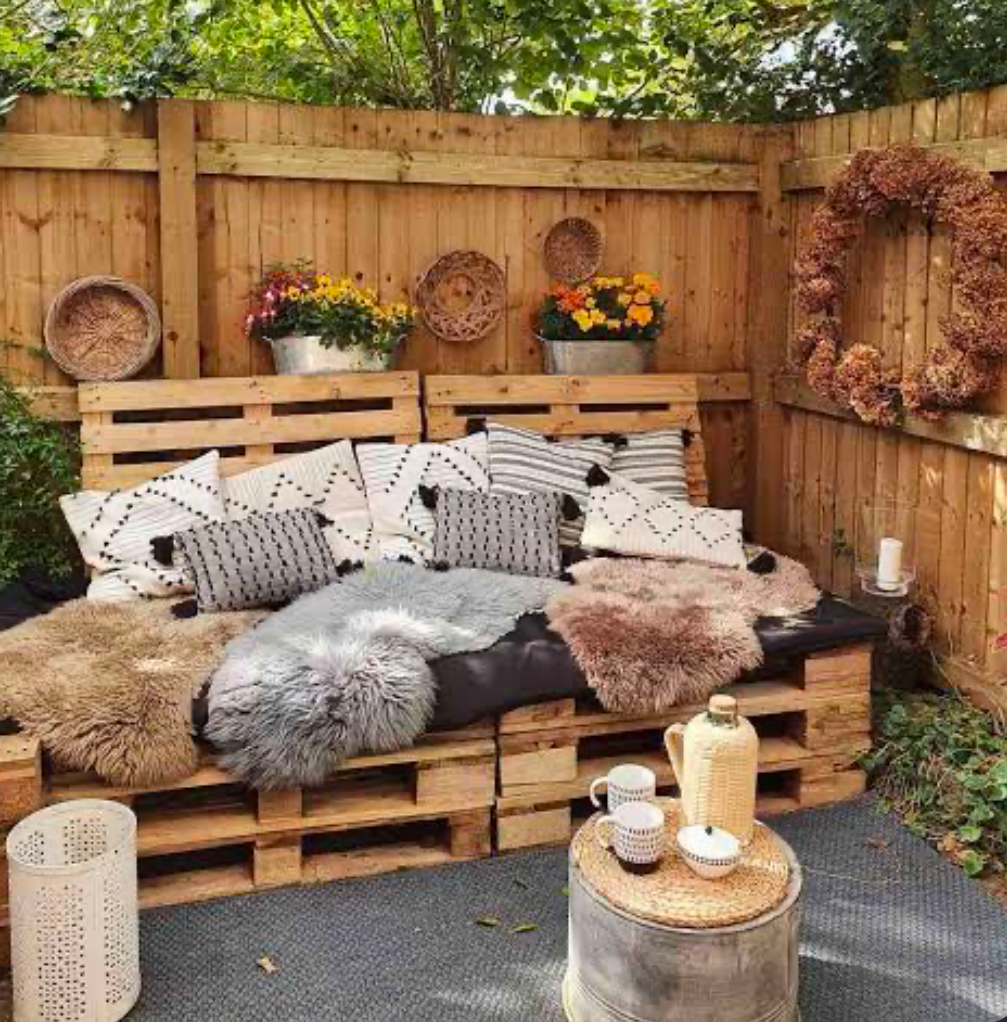 Pallets upcycled into sofas in a back yard.