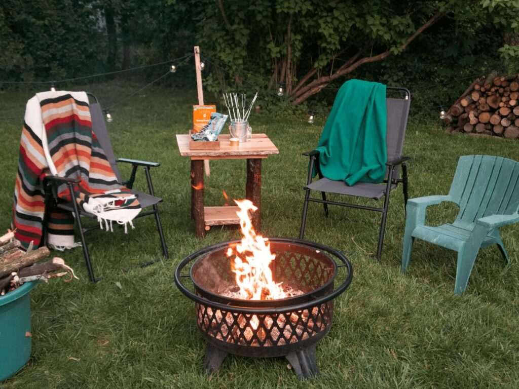 A mix of multiple furniture styles with a central fire pit for a camp-style backyard