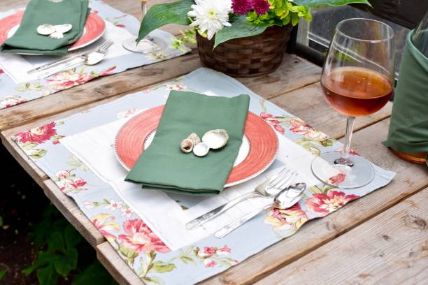 Fancy place setting for special events with beautiful flower arrangements and flower pots in outdoor patio.