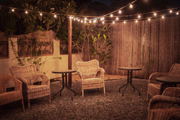 Outdoor patio setup in the gravel with fairy lights.