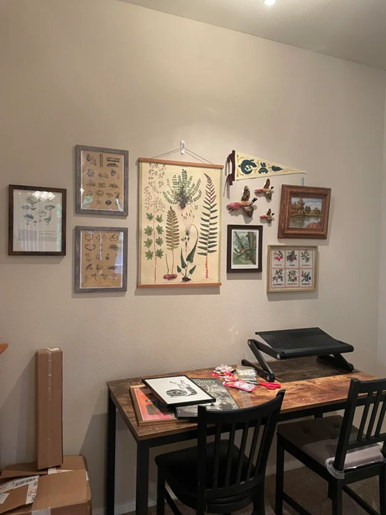 DIY botanical gallery wall above home office desk.