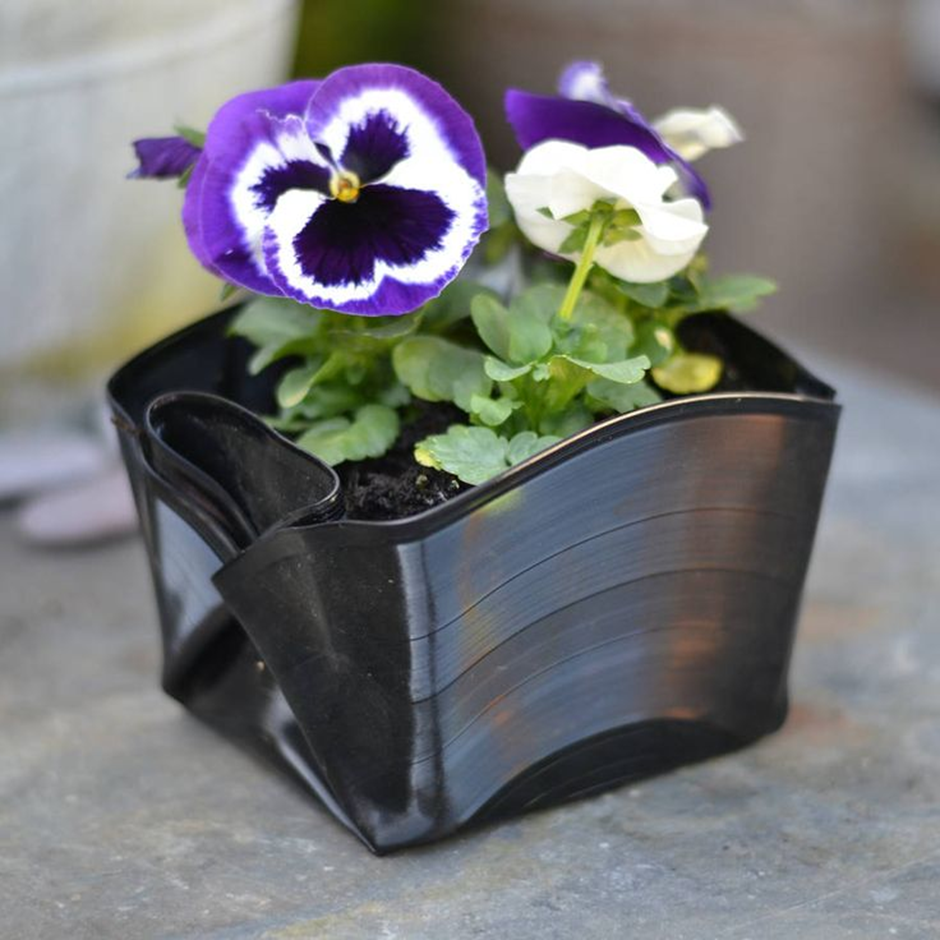 Upcycled vinyl record planter with blooming pansies.