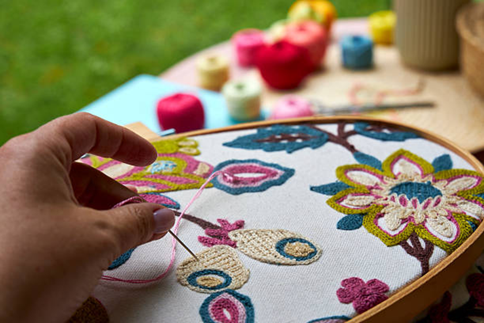 A hobbyist embroidering.