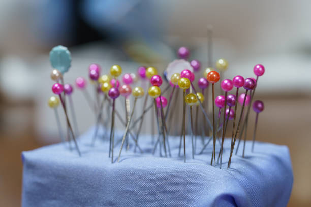 Several colored pins are pinned on the pincushion.