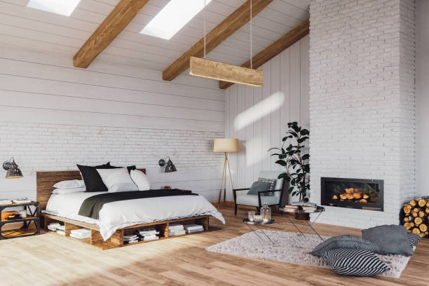 Modern rustic bedroom with wooden beams, pallet bed, white brick fireplace, and minimalist decor