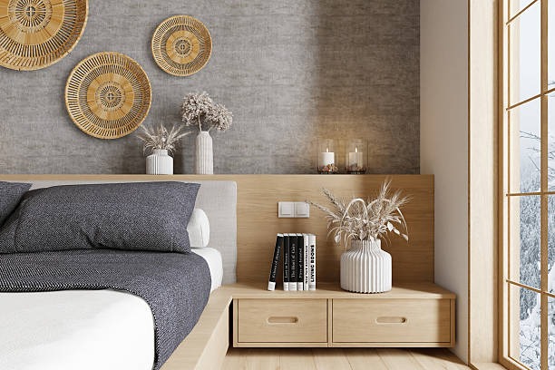 Minimalist bedroom with wooden nightstand, neutral bedding, woven wall decor, and natural light