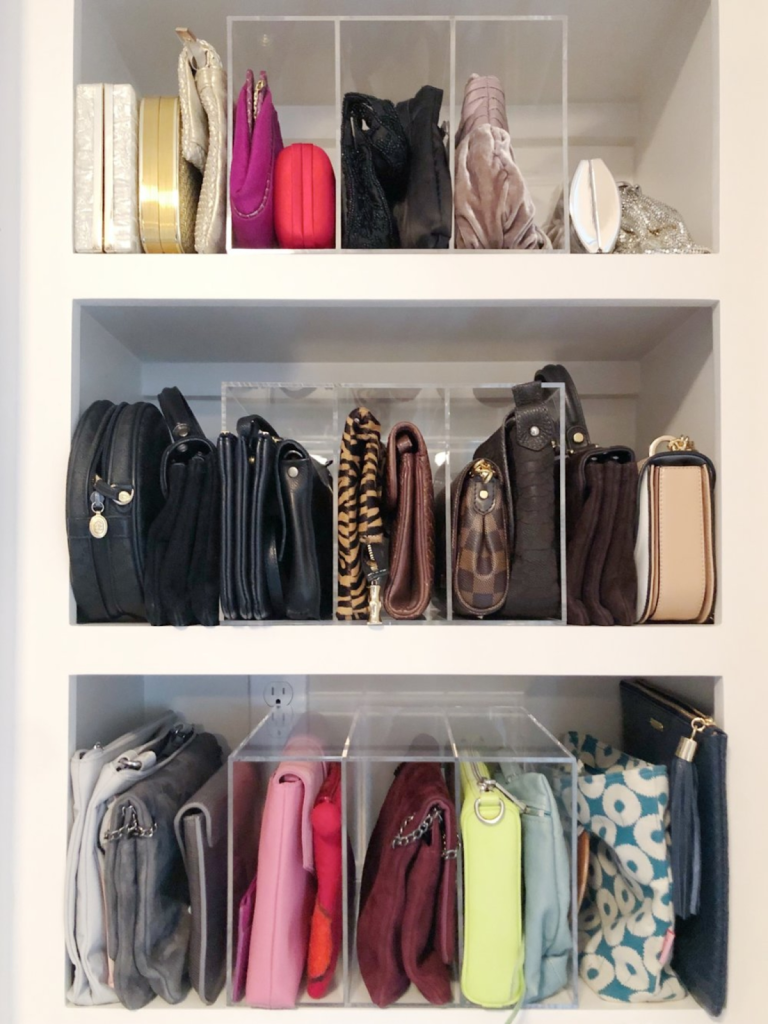 Clear acrylic purse organizers displaying handbags and clutches on closet shelves