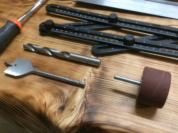 woodworking tools for farmhouse table renovation on stained wood surface